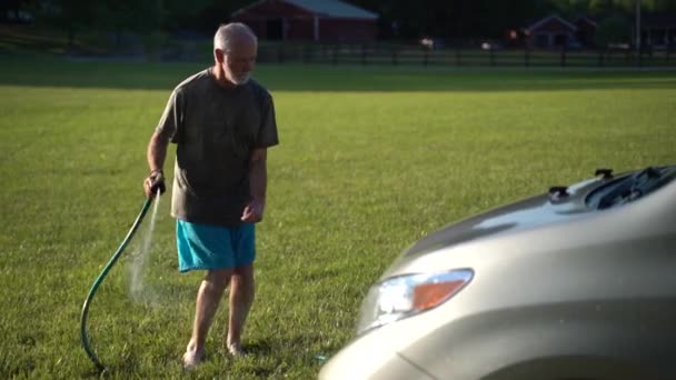 Man Washing Car While Dancing Doing Floss Spraying Hose Slow — Video Stock