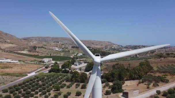 Wind Turbine Turning Wind Mediterranean Hilltop Aerial Closeup Pull Away — Stock video