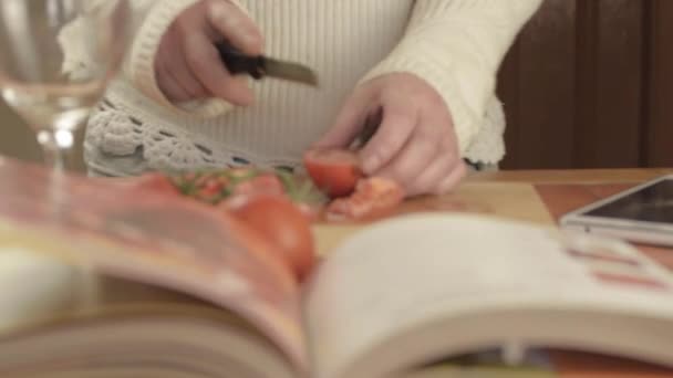 Hands Cutting Fresh Vine Tomatoes Kitchen Recipe Book Foreground — 图库视频影像