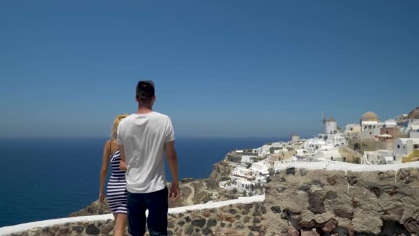 Young Couple Holds Hands Hugs Watching Romantic View Santorini Static — 图库视频影像