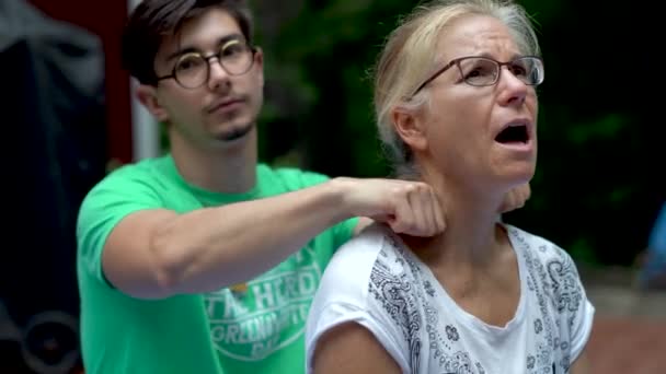 Handsome Teen Boy Giving His Mature Mother Neck Massage While — Wideo stockowe