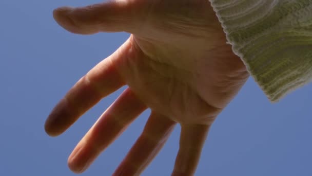 Single Hand Reaching Out Clear Blue Sky Medium Shot — Stok Video