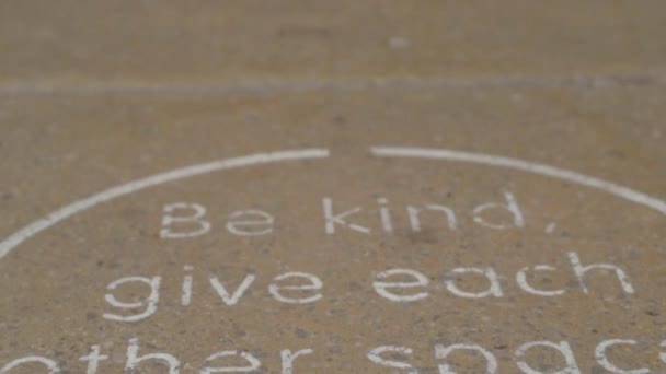 Compassionate Social Distancing Sign Pavement Floor — стоковое видео