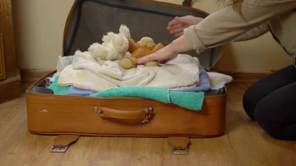 Parent Closing Suitcase Filled Clothes Toys Wide Shot — Stockvideo