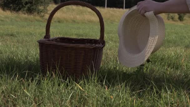 Hands Picking Straw Hat Woven Basket Medium Shot — Stockvideo