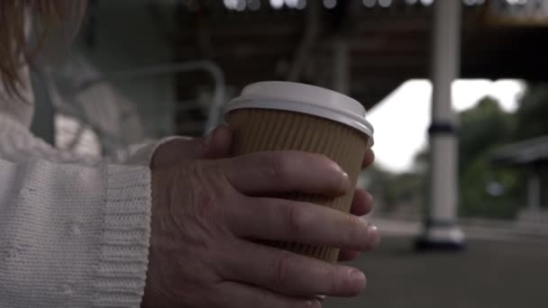 Hands Holding Takeout Coffee While Waiting Train Platform Medium Shot — Stock video