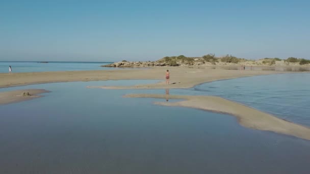 Drone Aerial View Woman Standing Elafonissi Beach Lagoon Reflection — Vídeos de Stock