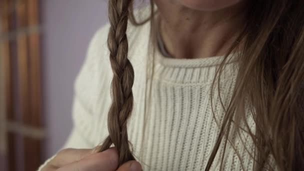 Woman Plaiting Long Hair Close Shot — стоковое видео