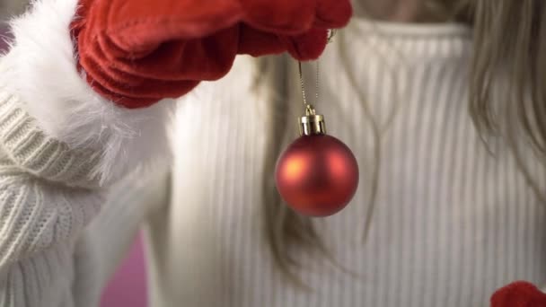 Woman Wearing Santa Gloves Holding Red Christmas Bauble Close Shot — Stock video