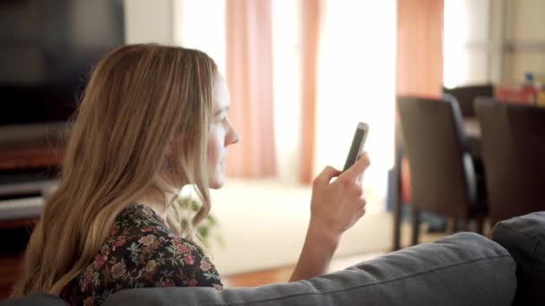 Woman Sitting Living Room Scrolls Smart Phone Gets Angry Throws — Stock Video