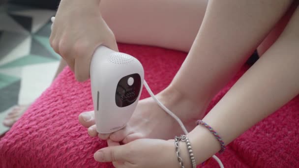 Woman Using Laser Hair Removal Device Her Toes Daytime Couch — 图库视频影像