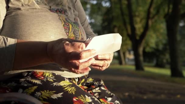 Mature Woman Reading Letter Park Medium Shot — Stock video