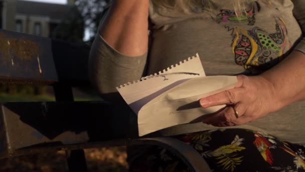 Hand Mature Woman Reading Letter Park Close Shot — Stock video