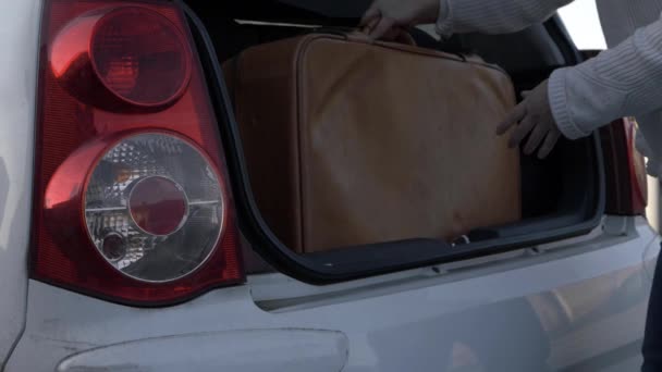 Woman Taking Old Brown Suitcase Out Car Boot Close Shot — ストック動画