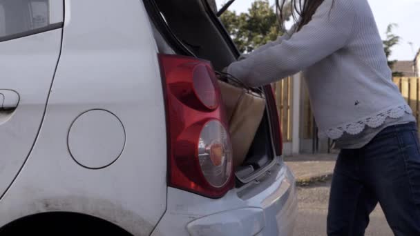 Woman Taking Old Brown Suitcase Out Car Boot Wide Shot — Vídeos de Stock