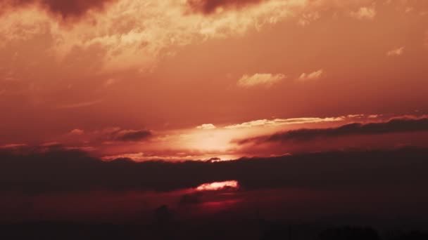 燃えるような輝きで雲の上に昇る壮大な日の出の時間の経過 赤い太陽を燃やす — ストック動画