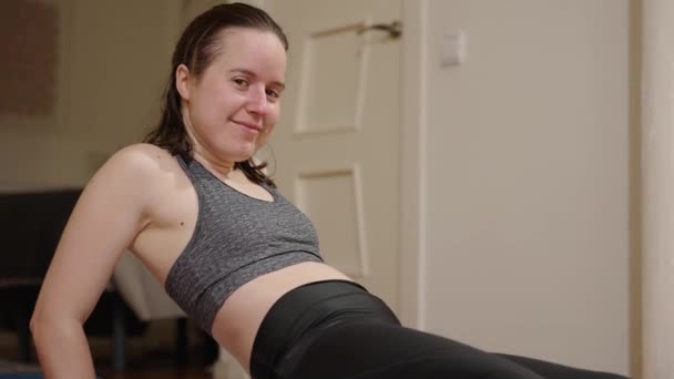 Home Workout Young Woman Looking Camera Whilst Holding Stress Positions — Stockvideo