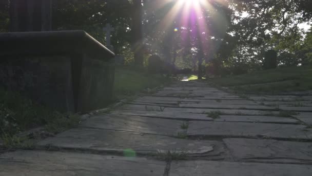 Sunbeams Old Churchyard Path Sunset Wide Tilting Shot — Stockvideo