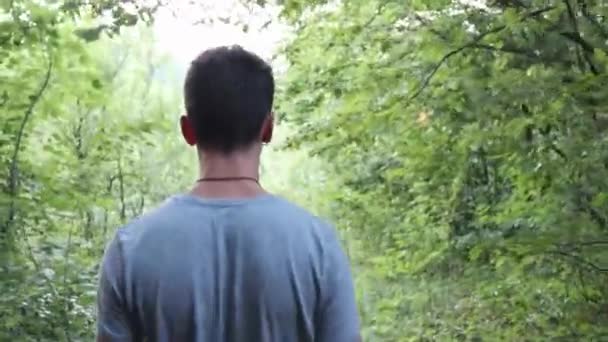 Man Walking Green Forest Shot — Stok video
