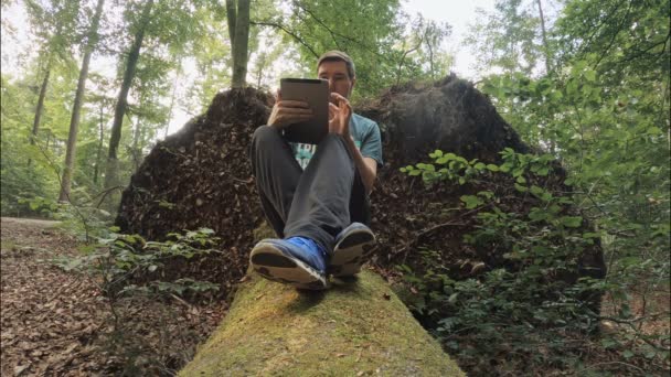 Working Pleasure Man Sitting Mossy Tree Trunk While His Work — Stockvideo