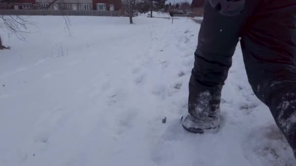 Young Child Walking Snow Side Road Winter Wearing Grey Snowpants — стоковое видео