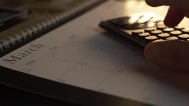 Hand Using Calculator March Calendar Close — Stock Video
