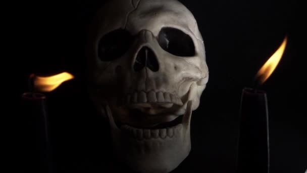 Human Skull Closing Mouth Two Candles Dark Background — Stockvideo