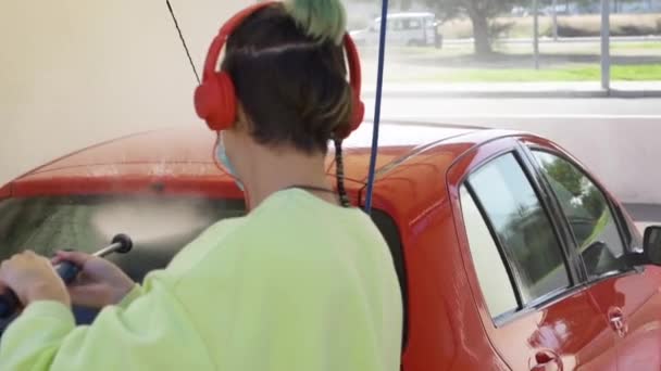 Woman Cleaning Red Car Mask While Listening Music New Normal — Vídeo de stock