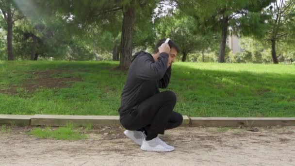 Crouched Runner Puts Helmets Ties Shoe — Stockvideo