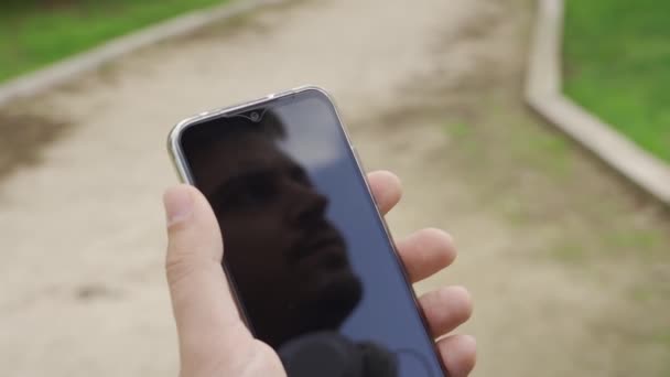 Reflection Man Mobile Looks Sky Touches Screen His Mobile Phone — Stockvideo