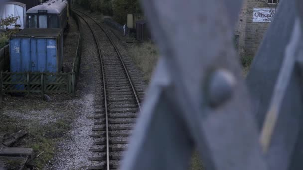 Train Track Parked Carriages View Bridge Wide Tilting Shot — стоковое видео