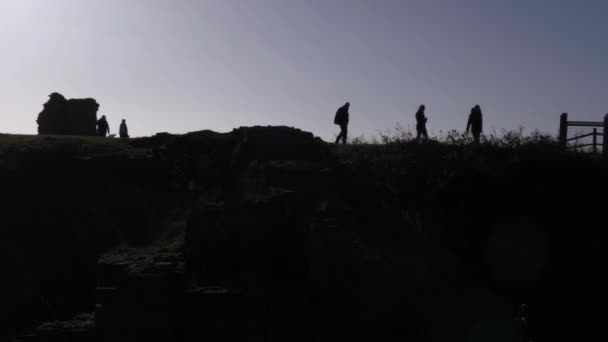 Group People Hiking Silhouetted Dusk Wide Panning Shot — Stockvideo