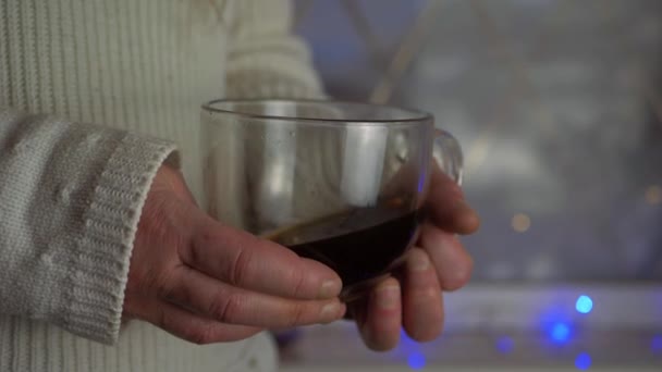 Woman Warming Hands Fresh Brewed Coffee Christmas Lights Background Close — Video