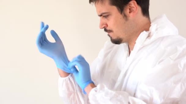 Doctor Ppe Suit Putting Blue Latex Gloves — Stockvideo