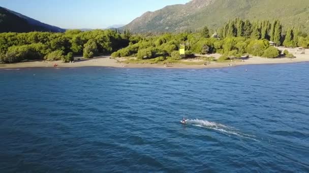 Pan Left Slow Motion Person Kitesurfing Puelo Lake Mountains Background — стоковое видео