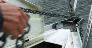 Pulling Up Chain With Anchor on Bow of Sailboat, Slow Motion. Sailing Concept