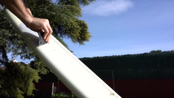 Surfer Removing Wax Board Gently — Video