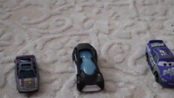 Small Toy Cars Lined White Rug High Angle Slider Right — Wideo stockowe