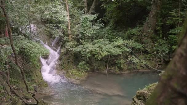Slow Motion Pan Right Left Reveal Waterfalling Blue Water Pond — 图库视频影像