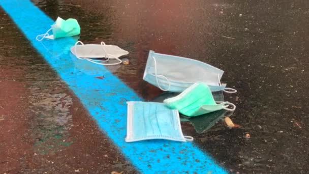 Pile Protective Facial Medical Masks Thrown Wet Ground Parking Lot — Stok Video
