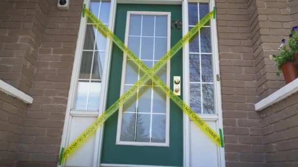 Crime Scene Cross Yellow Tape Front Door House — Stockvideo