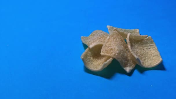 Close Tortilla Chips Rolling Blue Surface Stop Motion — Stockvideo