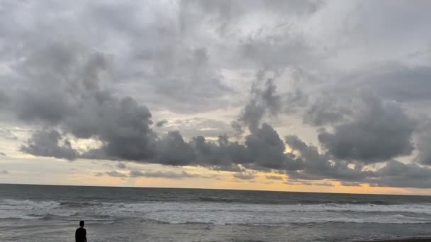 Silhouette Man Standing Beachfront Splashing Waves Sunset Beach Indonesia Static — Vídeos de Stock