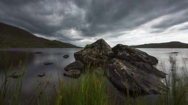 Motion Time Lapse Lake Grass Large Rocks Foreground Dark Cloudy — Stock video