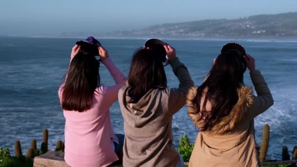 Slow Group Three Women Looking Sea Putting Colorful Caps Pichilemu — Stockvideo