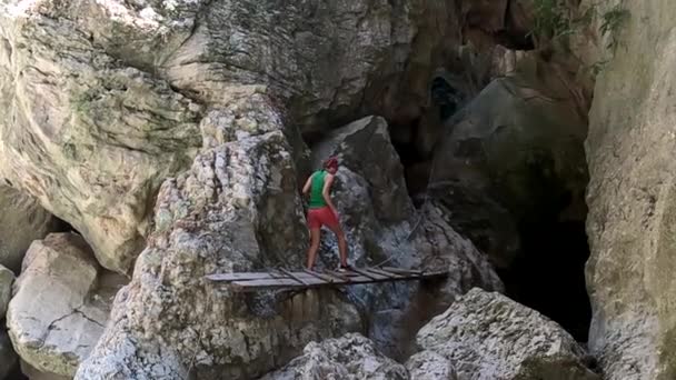 Slow Motion Woman Crosses Little Wooden Bridge Rocks — Stock Video
