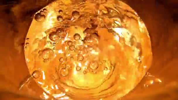 Pouring Water Glass Golden Effect Top View Close — Stockvideo