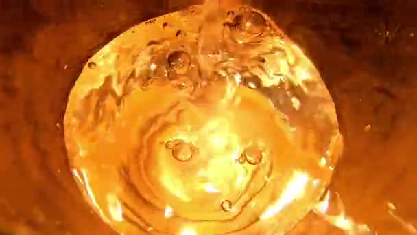 Golden Effect Water Being Poured Glass Top View Close — Stockvideo