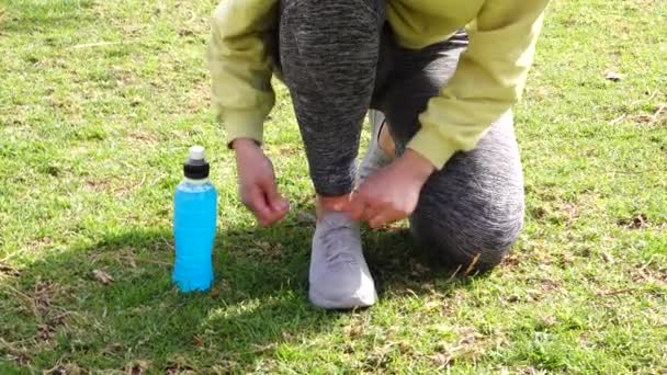 Atleta Atando Zapatillas Deporte Hierba Con Azul Bebida Isotónica Lado — Vídeos de Stock