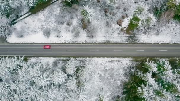 Aerial Tracking Red Car Which Driving Wintry Countryside Street Straight — Vídeo de Stock